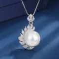 Close-up of elegant silver pearl pendant necklace with sparkling rhinestone leaf design details. - Pendant Only