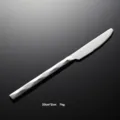 Stainless steel dinner knife detail view, modern geometric faceted handle table knife. - Dinner Knife