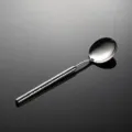 Stainless steel hammered dinner spoon detail view, elegant textured handle, polished surface. - Soup Spoon