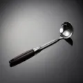 Detail view of 316 stainless steel soup ladle with sleek wooden handle and polished finish. - Soup Spoon