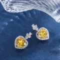 Elegante herzförmige Ohrringe mit gelbem Zirkonia Stein und funkelnden weißen Zirkonias. - Ohrstecker / Gelb