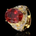 Close-up detail of vintage gold plated ring with large oval red gemstone and clear zircon stones. - Oval Vintage Style / Adjustable / Red Corundum Ring