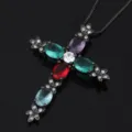 Cross pendant necklace featuring multi-color cubic zirconia stones and black finish. - Black & Gold