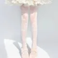 Detail shot of Lolita white sheer stockings with cute butterfly and bow pattern designs. - One Size / White