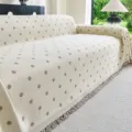 Beige pastoral style sofa cover blanket featuring elegant grey polka dots and bottom fringe. - Polka Dot White