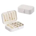 Portable travel jewelry box organizer with compartments for rings, necklaces, and earrings. - White