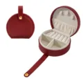 Portable round jewelry box with ring slots and necklace hooks for secure travel storage. - 10*9*4.5CM / Burgundy
