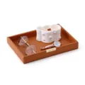 Brown leather storage tray with gold metal tag and decorative candle, glasses, and watch. - Storage Tray / Brown