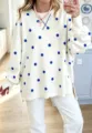 Detailed shot of women's loose polka dot sweatshirt with side slits and crew neck design. - S / Cream White