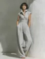 Close-up detail of the elegant linen sleeveless lapel wide-leg jumpsuit, resort style. - Light Gray