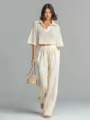 Beige hollow knit two-piece set featuring a lapel crop top and high-waist drawstring pants. - S / Top And Bottom / Ivory