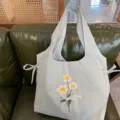 Detailed view of the sweet style nylon floral embroidered shoulder vest bag, featuring a lace bow. - Gray Lace Bowknot Flower Vest Bag