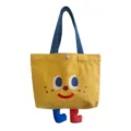 Lindo bolso de lona para almuerzo con piernas colgantes, bolso estudiantil para comidas diarias. - Cara Sonriente de Pecas Patitas Bento Amarillo Naranja