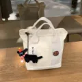 Canvas lunch tote bag with embroidered webbing strap, cute plush pendant, and secure zipper. - Cookie Style / With Black Doll Charm
