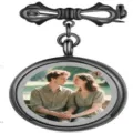 Detailed view of black metal bow brooch with round photo locket tray for custom memories. - Gunmetal