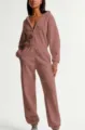 Close-up view of the casual hooded jumpsuit showcasing the soft fleece fabric and zipper detail. - XS / Dusty Pink