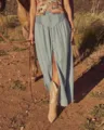 Light blue denim maxi skirt featuring high waist smocked design and front button closure. - S / Blue