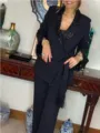 Black two-piece suit detail showing sequin lapel, long sleeves and tassel belt in room. - S / Top And Bottom / Black