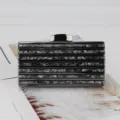 Acrylic evening clutch bag for women, stylish striped hard case design with metal closure. - Black