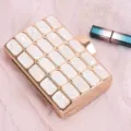 White acrylic evening clutch bag with rose gold metal trim for stylish party use - White