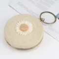 Chic round straw woven clutch bag featuring cute daisy flower and retro bronze metal ring handle. - Off White