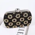 Elegant black rhinestone evening clutch bag featuring crystal flower pattern and metal frame. - Black