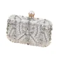 Close-up detail of silver beaded evening clutch with sparkling rhinestones and elegant pearl clasp. - 19*5*12cm / Silver