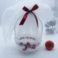 White wicker storage basket with white sheer veil and red ribbon bow for gifts and floral arrangement. - Round Basin Diameter 18x22cm / Burgundy
