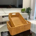 Detail view of the 2-piece handcrafted rectangular faux rattan storage basket with double handles. - Storage Basket Two-Piece Set / Two-Piece Set / Natural Wood Color
