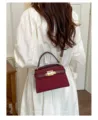 Chic solid color retro crossbody bag for women, elegant top handle shoulder bag with lock. - Red