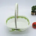 White woven basket with green ribbon handle, perfect for flower arrangement, gift or storage use. - Light Green