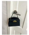 Chic black mini handbag with retro gold metal lock design, perfect for daily commuting and style. - Black