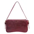 Red leather shoulder bag with floral embossed flap and elegant curved bottom design stylish. - Red