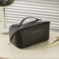Black PU leather cosmetic bag with gold zipper and handle, portable travel makeup pouch. - Black