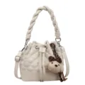 White quilted bucket bag in white with braided handle and cute puppy charm accessory. - With Pendant / Off White