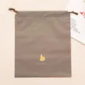 Grey PVC drawstring storage bag with cute house print for travel and stationery organization. - Brown House Hair Claw