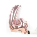 Detailed view of a shiny rose gold number foil balloon, perfect for birthday party decorations. - Number 4 / 32-inch / Rose Gold