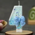 Blue bow number 4 birthday candle with sparkling blue glitter, perfect for kids cake decor. - Blue Bow Candle 4