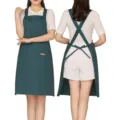 Dark green cross back apron with adjustable straps and large pocket. Ideal for cafe cooking. - Polyester / Dark Green