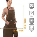 Cross-back canvas work apron with leather reinforcement, multiple pockets, and adjustable fit. - Dark Coffee