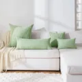 Corduroy long body pillow scene detail displaying soft green striped cushion covers. - Matcha Green