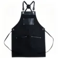Tablier de travail noir en toile avec lanières et poches en cuir pour cuisine, barbecue et café. - Noir avec cuir noir contrasté