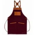 Tablier de travail en toile avec bretelles en cuir et poches, parfait pour cuisine et café. - Rouge vin avec cuir marron contrasté