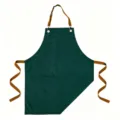 Grembiule in tela verde scuro con cinghie marroni e tasca anteriore per cucina e cottura. - Verde Scuro