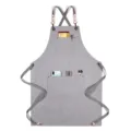Tablier gris en toile avec bretelles croisées, détails en cuir et poches pour cuisine. - Toile Épaisse Sangle Style F / Gris