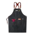 Dark denim apron with leather cross straps and multiple utility pockets for daily work use. - Round Badge Belt Denim Black Style R
