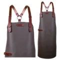 Braune PU-Leder Arbeitsschürze mit Kreuzgurt und Metallbeschlägen für Küche und Salon. - Y-Lederriemen, Graubraun