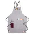 Grey canvas work apron with cross-back straps and multi-pockets for kitchen, cafe, or salon use. - Style D / Gray