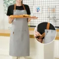 Grey canvas kitchen apron with brown straps and pocket, stylish cooking workwear for chef. - Waterproof Canvas Halterneck Contrast - Light Grey