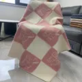 Knitted wool blend sofa throw blanket with pink and white checkered rocking horse pattern. - 130x160cm / Pink